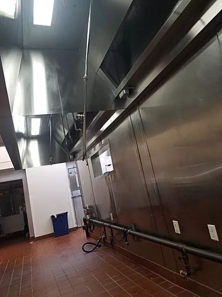 Commercial kitchen interior in Dublin, OH, featuring a stainless steel exhaust hood system, part of kitchen exhaust cleaning in Dublin OH services.